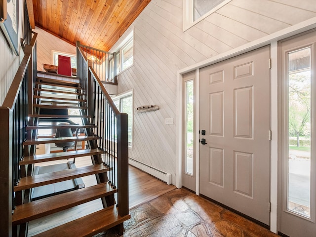 2904 Le Homme Dieu Vw NE, Alexandria, MN 56308 - entryway featuring lofted ceiling, baseboard heating, wood ceiling, stairway, and wooden walls