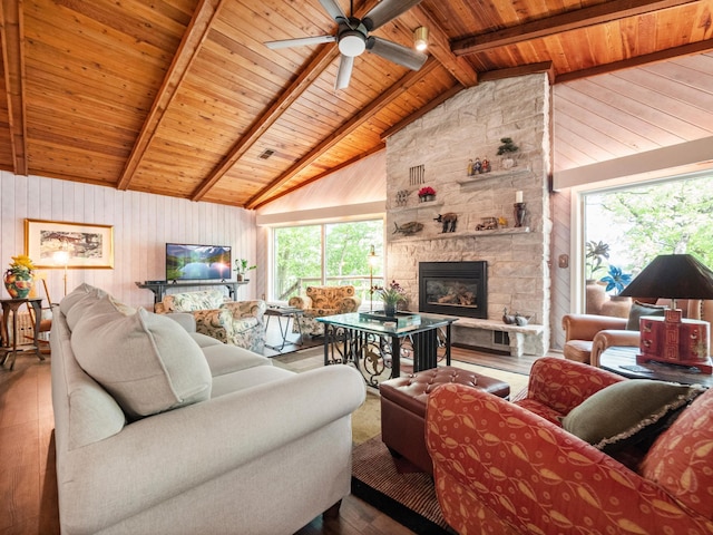 2904 Le Homme Dieu Vw NE, Alexandria, MN 56308 - living room with wood ceiling with exposed beams, a fireplace, a ceiling fan, wood finished floors, and wood walls