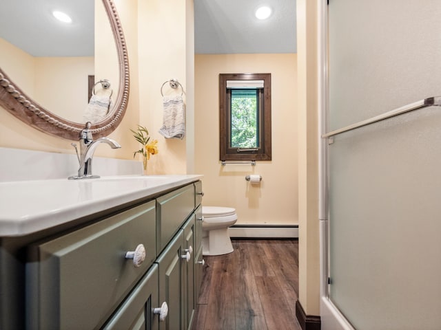 2904 Le Homme Dieu Vw NE, Alexandria, MN 56308 - bathroom featuring baseboard heating, wood finished floors, toilet, vanity, and recessed lighting
