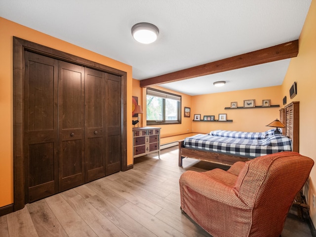2904 Le Homme Dieu Vw NE, Alexandria, MN 56308 - bedroom with beamed ceiling, light wood-style flooring, a closet, baseboards, and a baseboard radiator