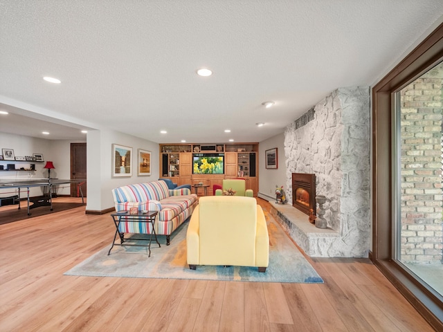 2904 Le Homme Dieu Vw NE, Alexandria, MN 56308 - living area featuring wood finished floors, a textured ceiling, baseboards, built in features, and recessed lighting