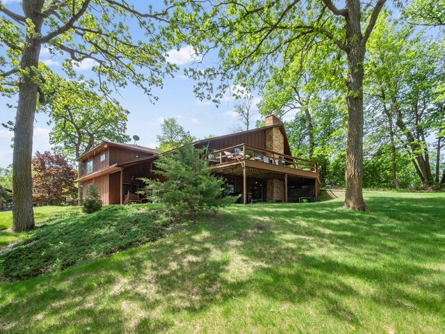2904 Le Homme Dieu Vw NE, Alexandria, MN 56308 - back of house featuring a chimney, a deck, and a lawn