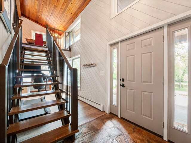 2904 Le Homme Dieu Vw NE, Alexandria, MN 56308 - foyer with lofted ceiling, baseboard heating, wood ceiling, stairway, and wooden walls
