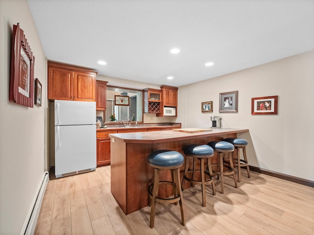 2904 Le Homme Dieu Vw NE, Alexandria, MN 56308 - kitchen featuring white appliances, a baseboard heating unit, light wood-style flooring, a breakfast bar, and recessed lighting