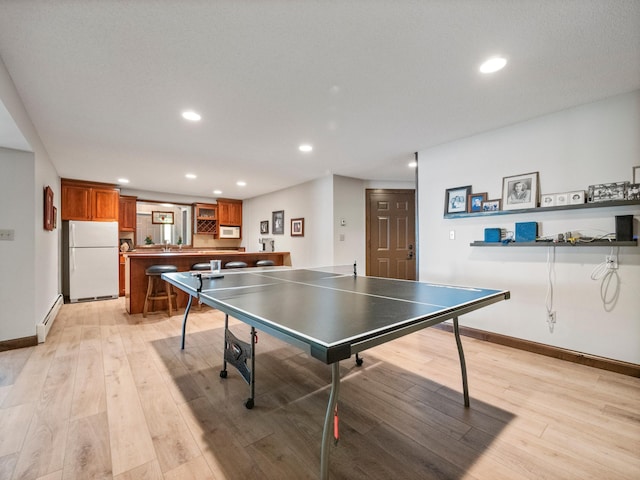 2904 Le Homme Dieu Vw NE, Alexandria, MN 56308 - rec room featuring baseboards, light wood-style flooring, recessed lighting, and a baseboard radiator
