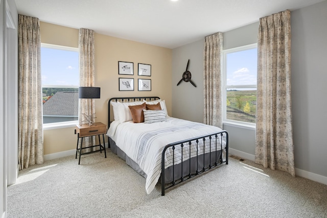 carpeted bedroom with visible vents and baseboards