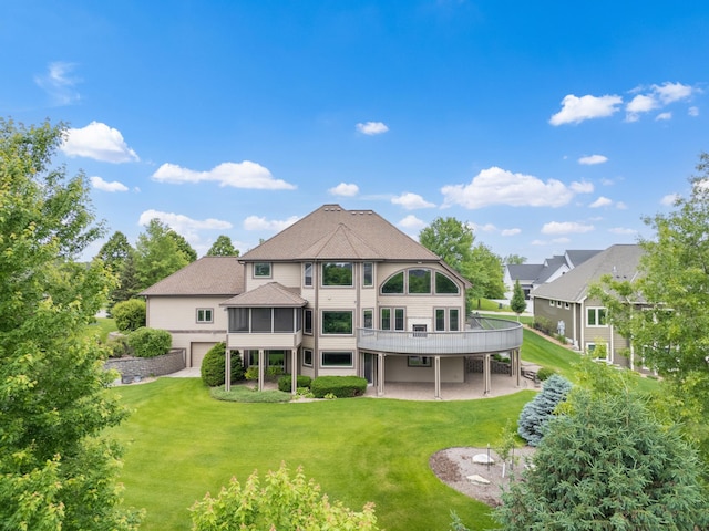 1502 Epperstone Enclave, Byron, MN 55920 - back of property with a garage, a patio, a yard, and a shingled roof