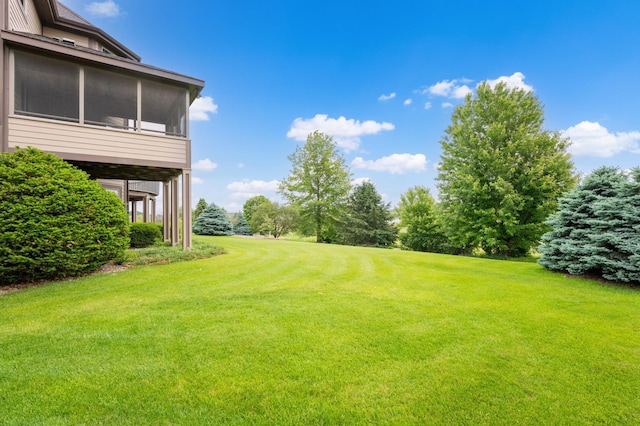 1502 Epperstone Enclave, Byron, MN 55920 - view of grassy yard with view of wooded area and a sunroom
