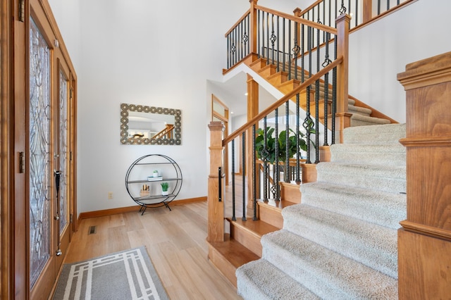 1502 Epperstone Enclave, Byron, MN 55920 - foyer with stairs, wood finished floors, and a high ceiling