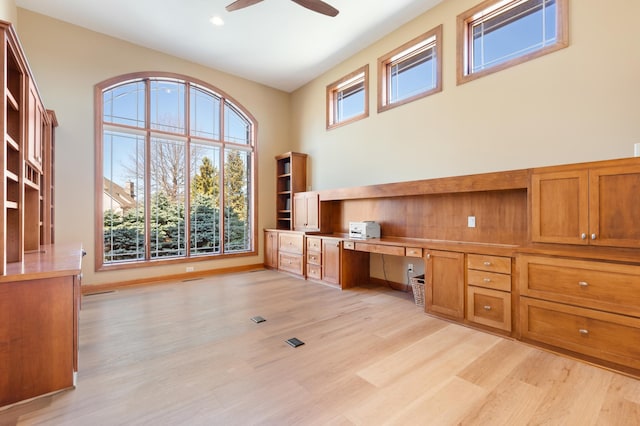 1502 Epperstone Enclave, Byron, MN 55920 - unfurnished office with built in desk, light wood-style floors, ceiling fan, a towering ceiling, and recessed lighting