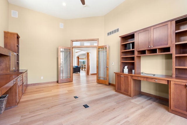 1502 Epperstone Enclave, Byron, MN 55920 - unfurnished office with french doors, a towering ceiling, light wood-type flooring, arched walkways, and built in desk