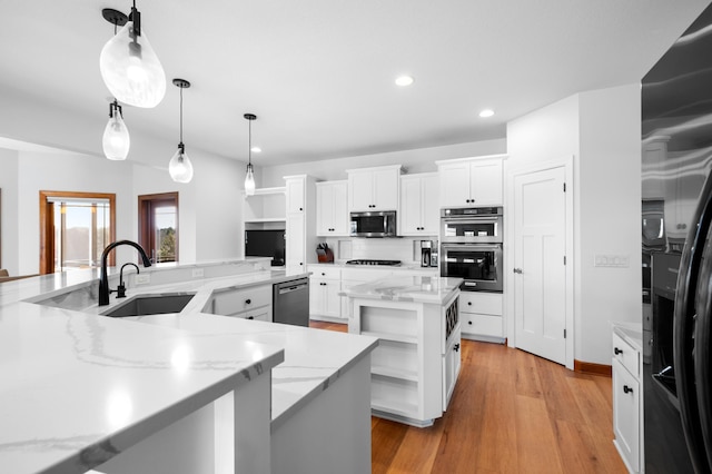1502 Epperstone Enclave, Byron, MN 55920 - kitchen with open shelves, stainless steel appliances, a large island with sink, recessed lighting, and white cabinetry