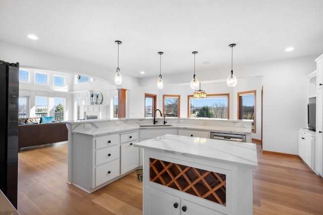 1502 Epperstone Enclave, Byron, MN 55920 - kitchen featuring a spacious island, open floor plan, healthy amount of natural light, recessed lighting, and light wood-style flooring