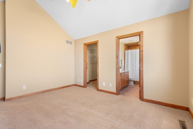 1502 Epperstone Enclave, Byron, MN 55920 - unfurnished bedroom with light carpet, a walk in closet, vaulted ceiling, ensuite bathroom, and a closet