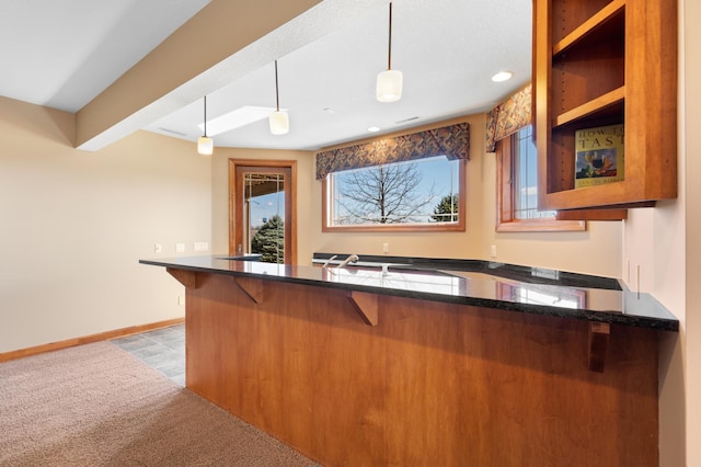 1502 Epperstone Enclave, Byron, MN 55920 - kitchen with plenty of natural light, a kitchen breakfast bar, recessed lighting, decorative light fixtures, and brown cabinetry
