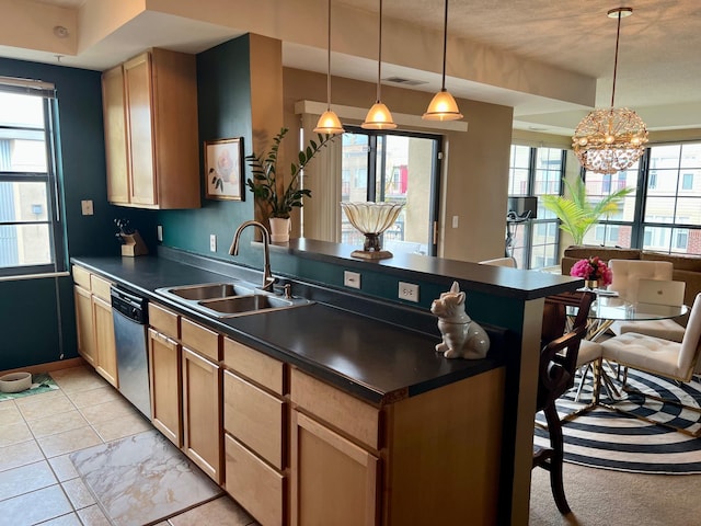 kitchen with a peninsula, a sink, stainless steel dishwasher, dark countertops, and decorative light fixtures