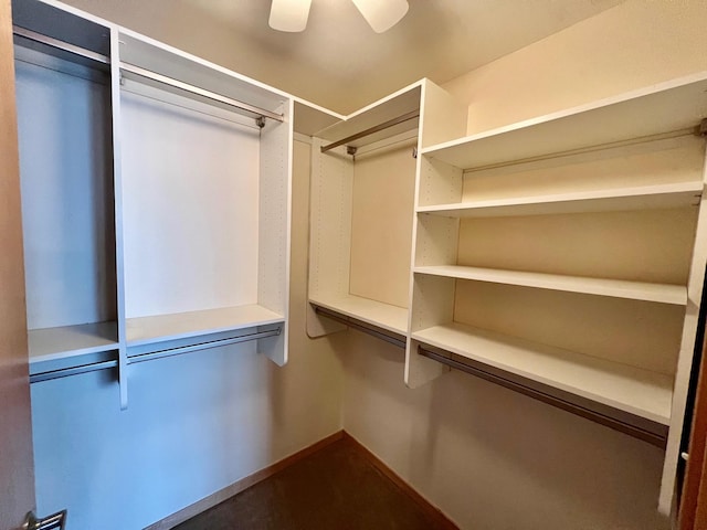 walk in closet with ceiling fan