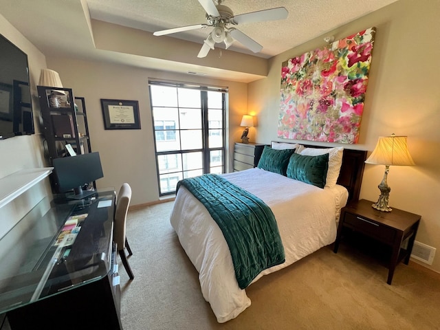 carpeted bedroom featuring visible vents, ceiling fan, a textured ceiling, and baseboards