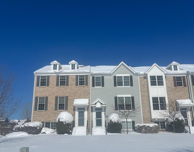 view of front of property with entry steps and brick siding