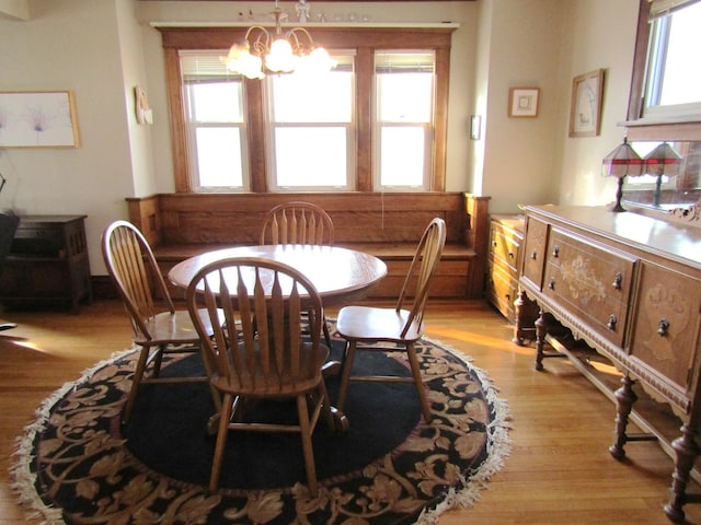 dining space with a chandelier and light wood-type flooring