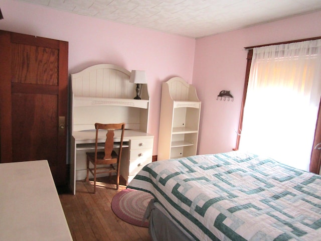 bedroom with wood-type flooring