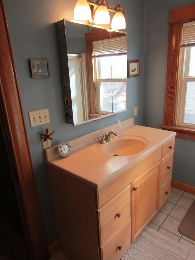 bathroom featuring baseboards, vanity, and tile patterned floors