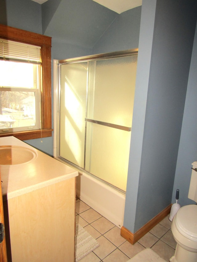 bathroom with baseboards, combined bath / shower with glass door, toilet, and tile patterned floors