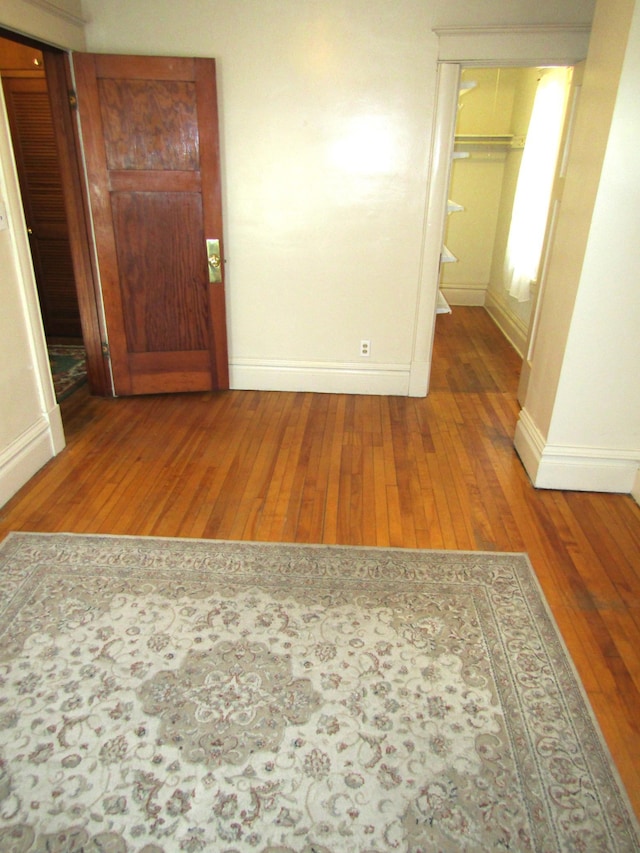 spare room featuring baseboards and hardwood / wood-style floors