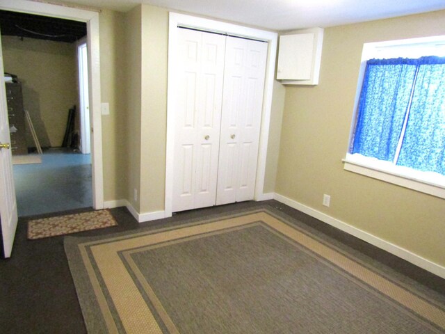 unfurnished bedroom featuring a closet and baseboards