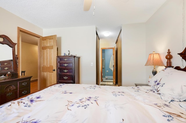 bedroom with a textured ceiling and ceiling fan