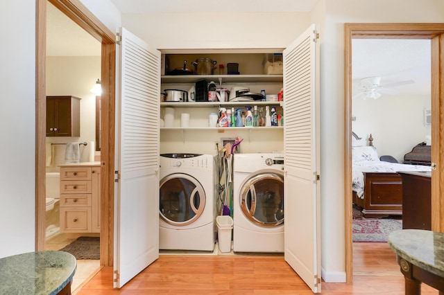 laundry area featuring ceiling fan, separate washer and dryer, light wood-style flooring, and laundry area