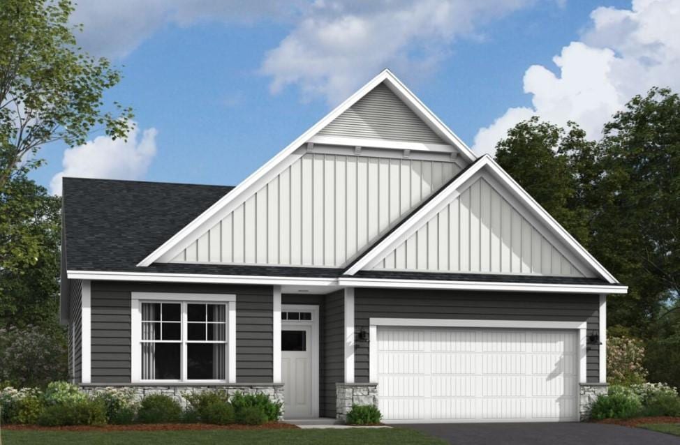 view of front of property featuring roof with shingles, board and batten siding, a garage, stone siding, and driveway