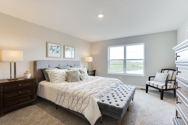 bedroom with baseboards and light colored carpet