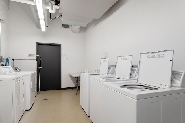 shared laundry area with light floors, washing machine and dryer, and visible vents