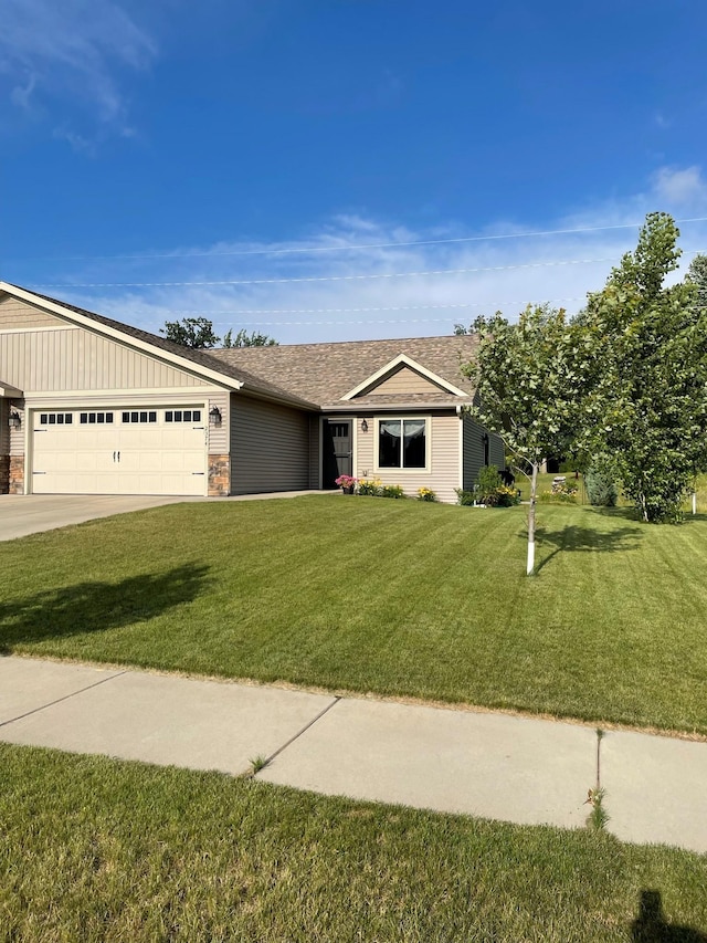 ranch-style house featuring driveway, an attached garage, and a front lawn