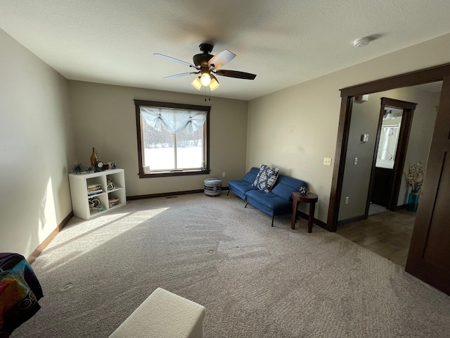 unfurnished room with baseboards, carpet, ceiling fan, and a textured ceiling