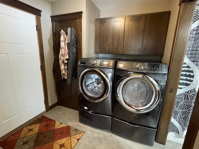 washroom featuring washer and dryer and cabinet space