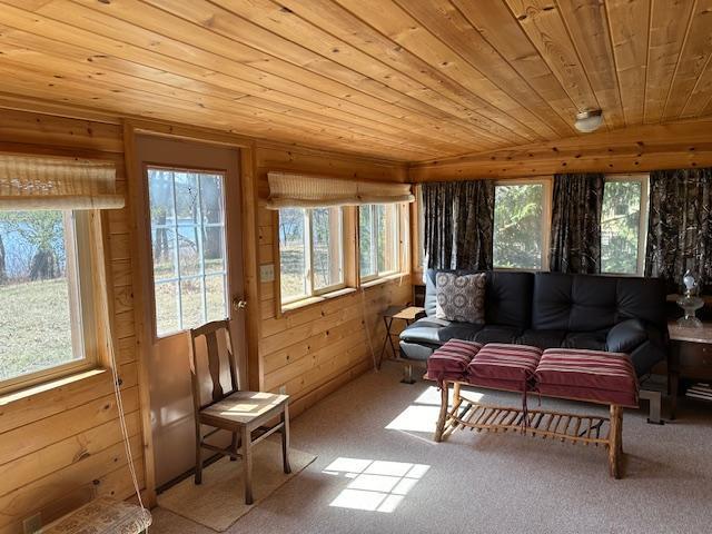 sunroom / solarium featuring wooden ceiling