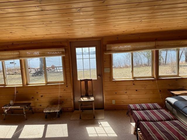 unfurnished sunroom featuring wood ceiling