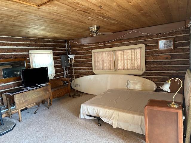 bedroom with wood ceiling and carpet flooring