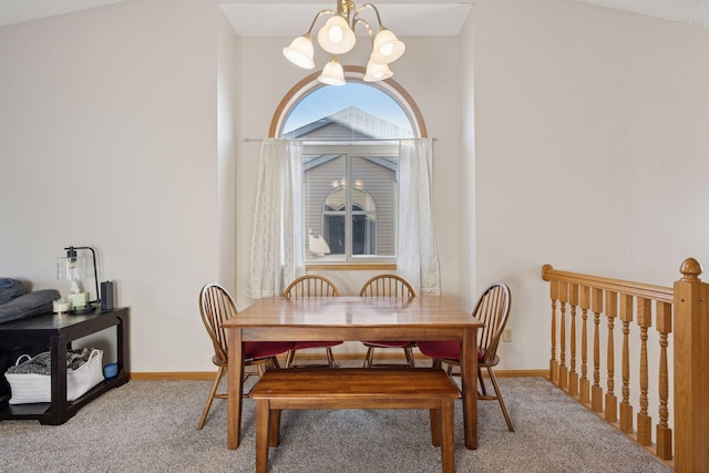 carpeted dining room with baseboards and a notable chandelier