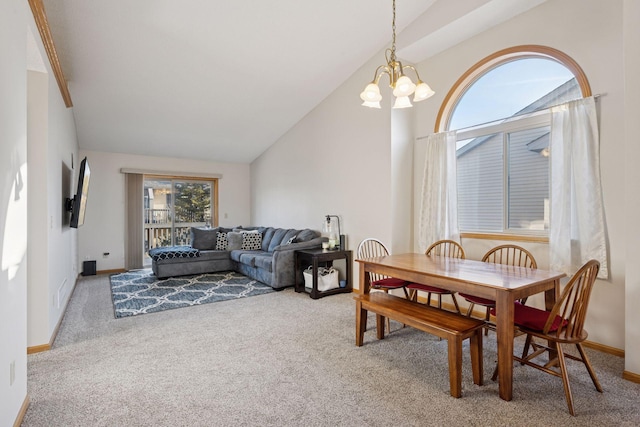 dining room featuring a chandelier, carpet flooring, high vaulted ceiling, and baseboards