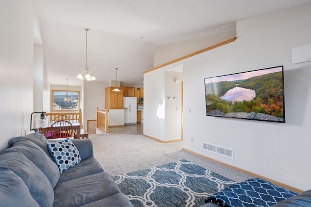 living room with light carpet, visible vents, baseboards, and vaulted ceiling