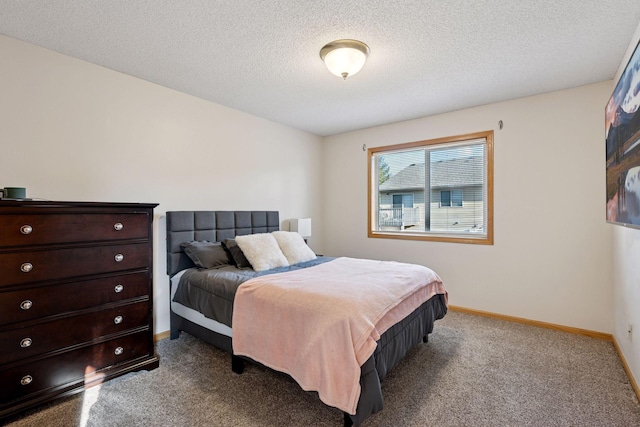 carpeted bedroom with baseboards and a textured ceiling