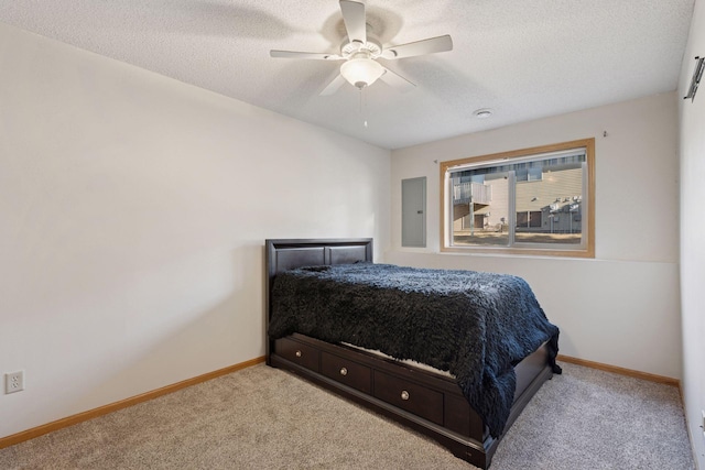 bedroom with a ceiling fan, baseboards, electric panel, a textured ceiling, and carpet flooring