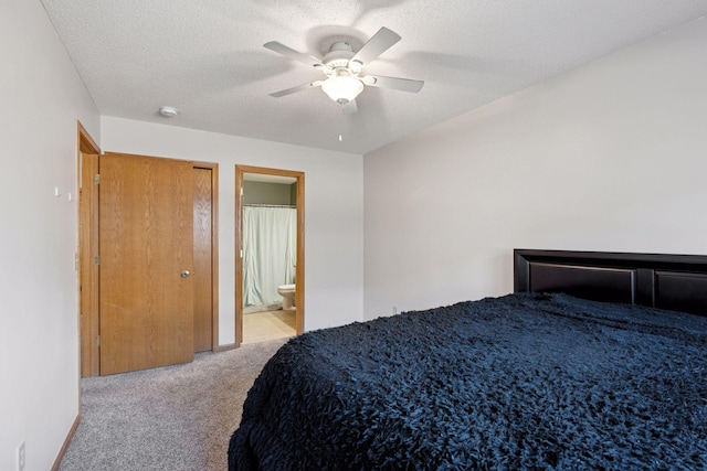 carpeted bedroom featuring connected bathroom, a textured ceiling, and a ceiling fan