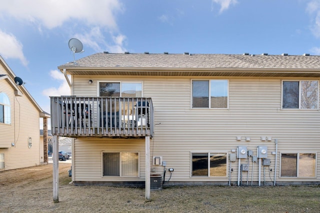 rear view of property with roof with shingles