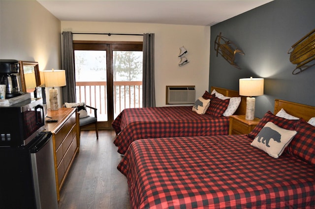 bedroom featuring access to outside, dark wood-style flooring, and a wall mounted air conditioner