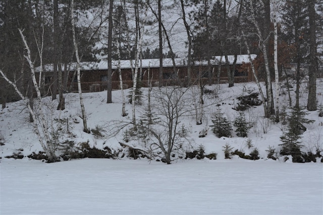 yard layered in snow featuring fence