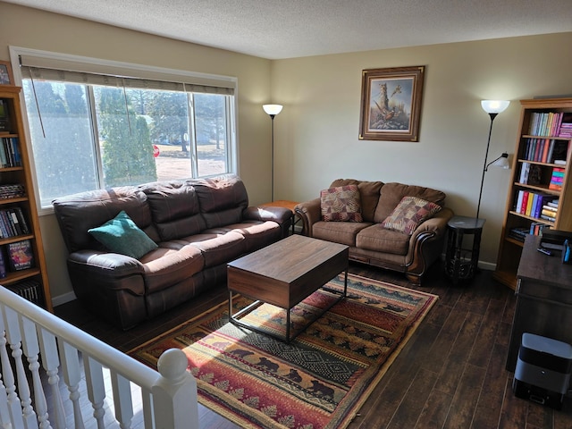 living area featuring baseboards, a textured ceiling, and dark wood-style floors